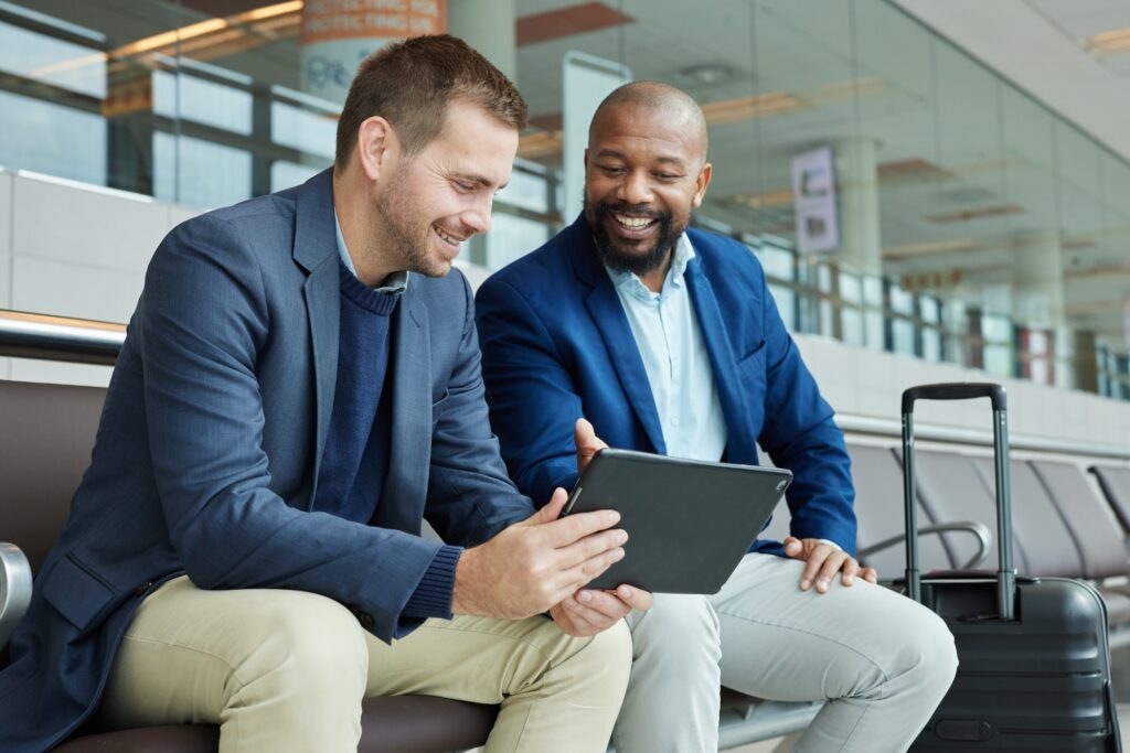 Airport, business team people and tablet talking of flight schedule, travel news or fintech managem